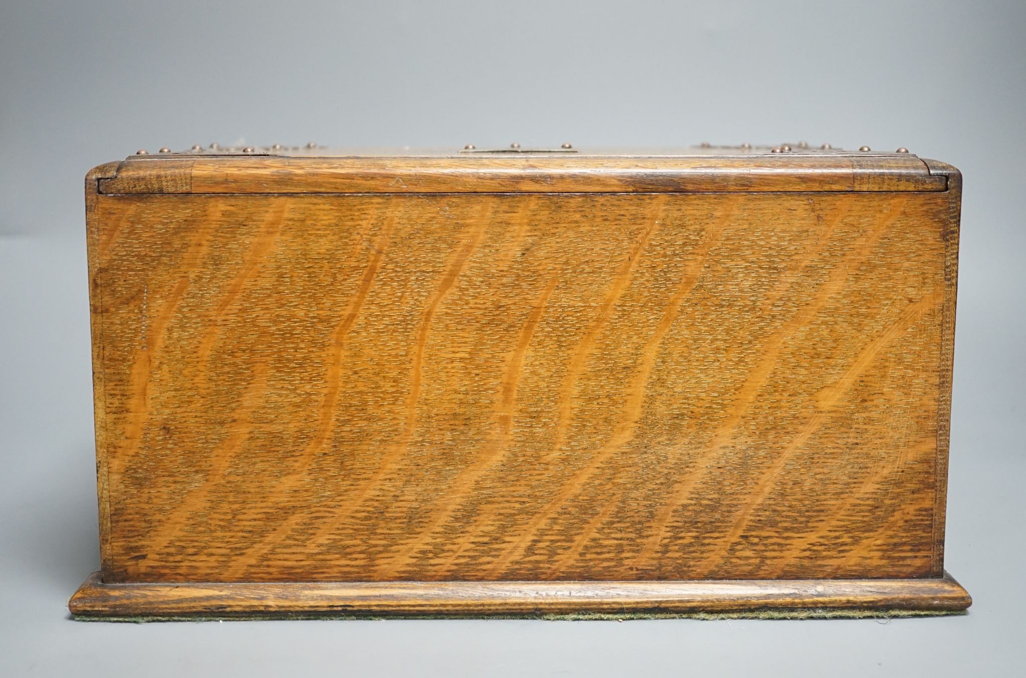 A Victorian oak smoker's box, with brass mounting, 30 cms wide x 17 cms high.